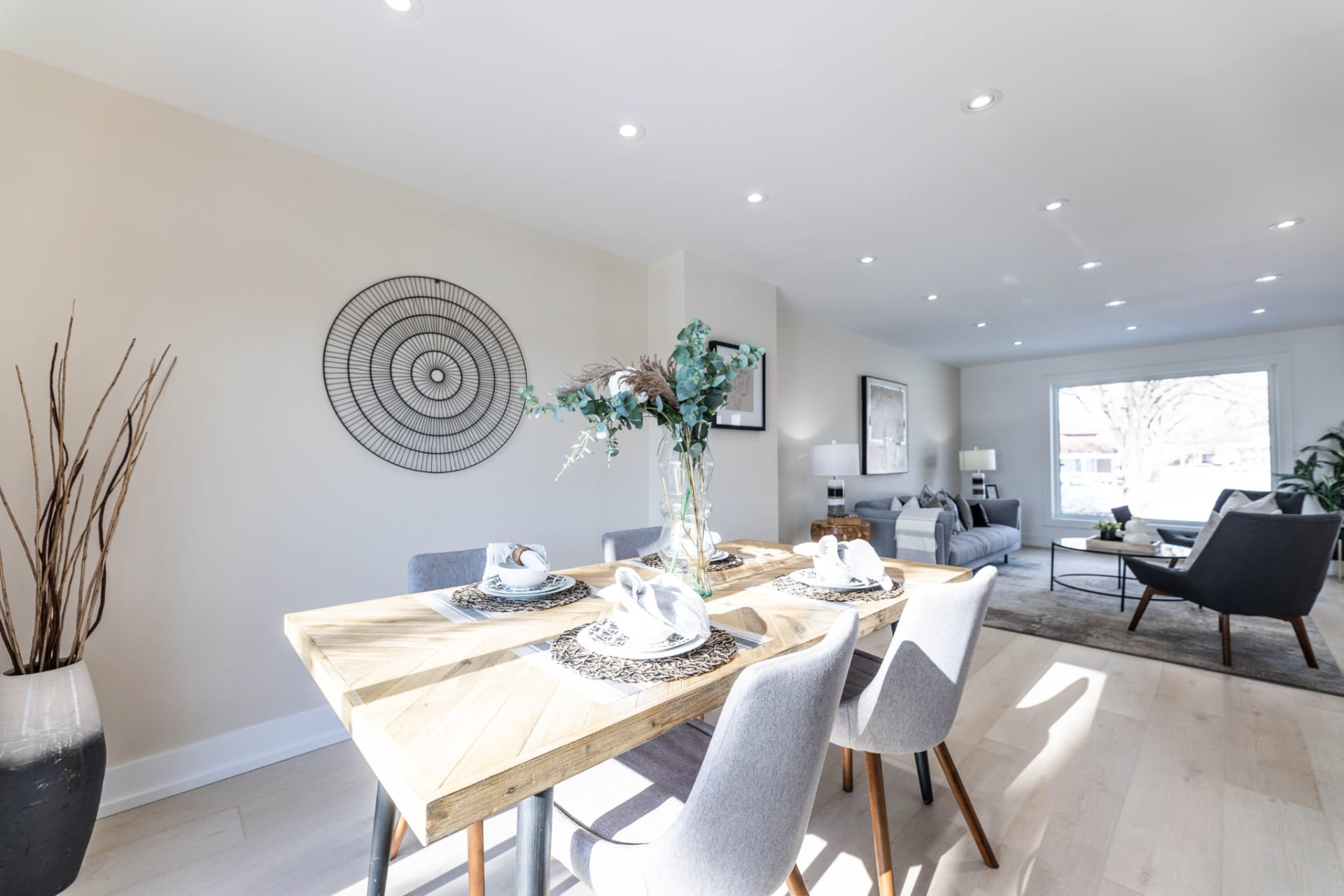 Staged dining area with reclaimed wood table and grey chairs