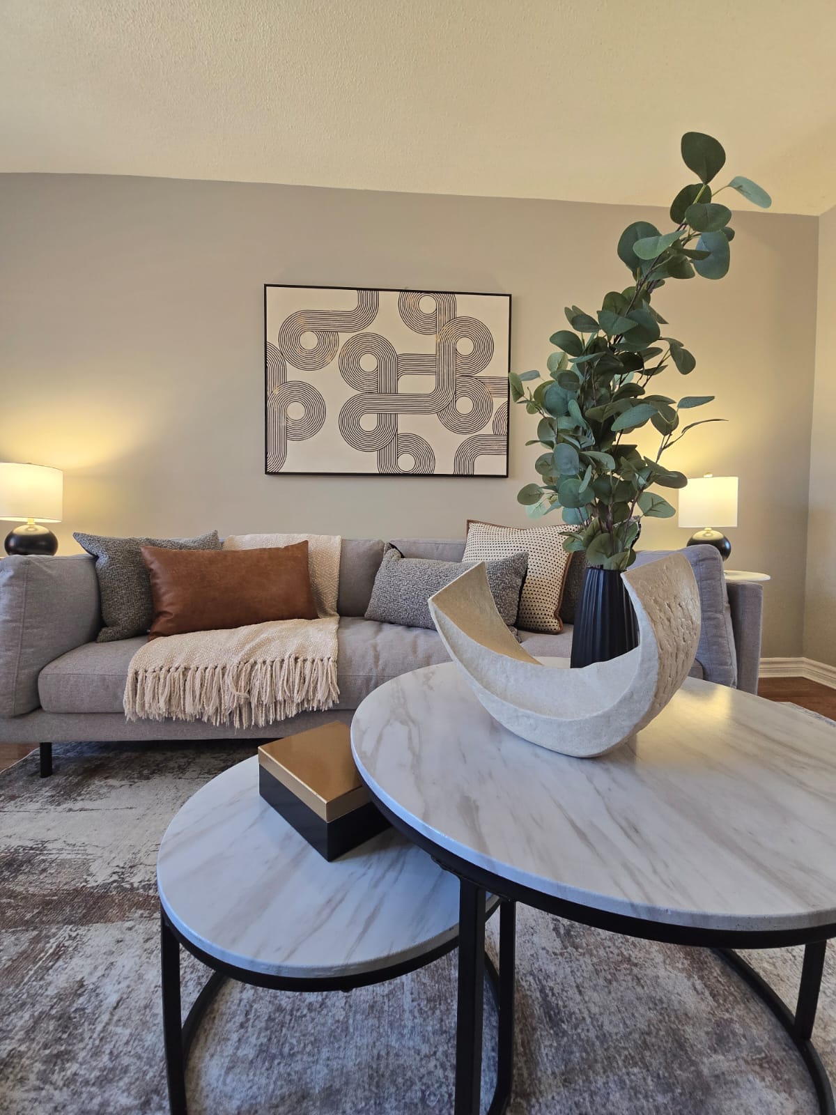 Coffee table vignette with marble tables and eucalyptus stems