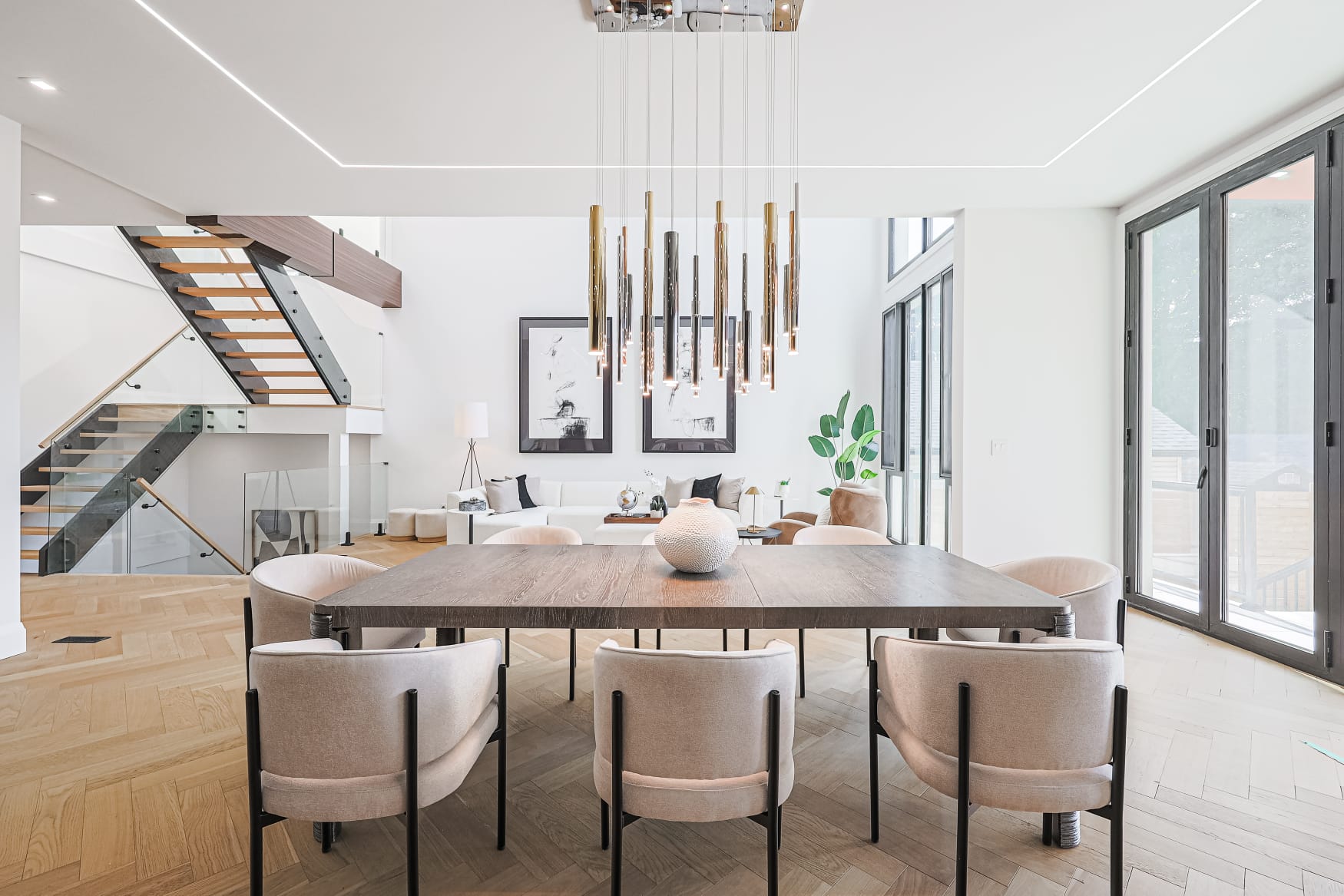 Double-height dining room with sculptural pendant cluster